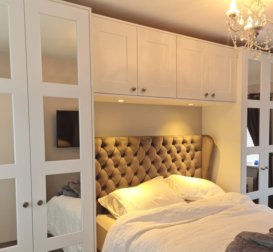 White fitted wardrobes built around a bed in a Dublin bedroom