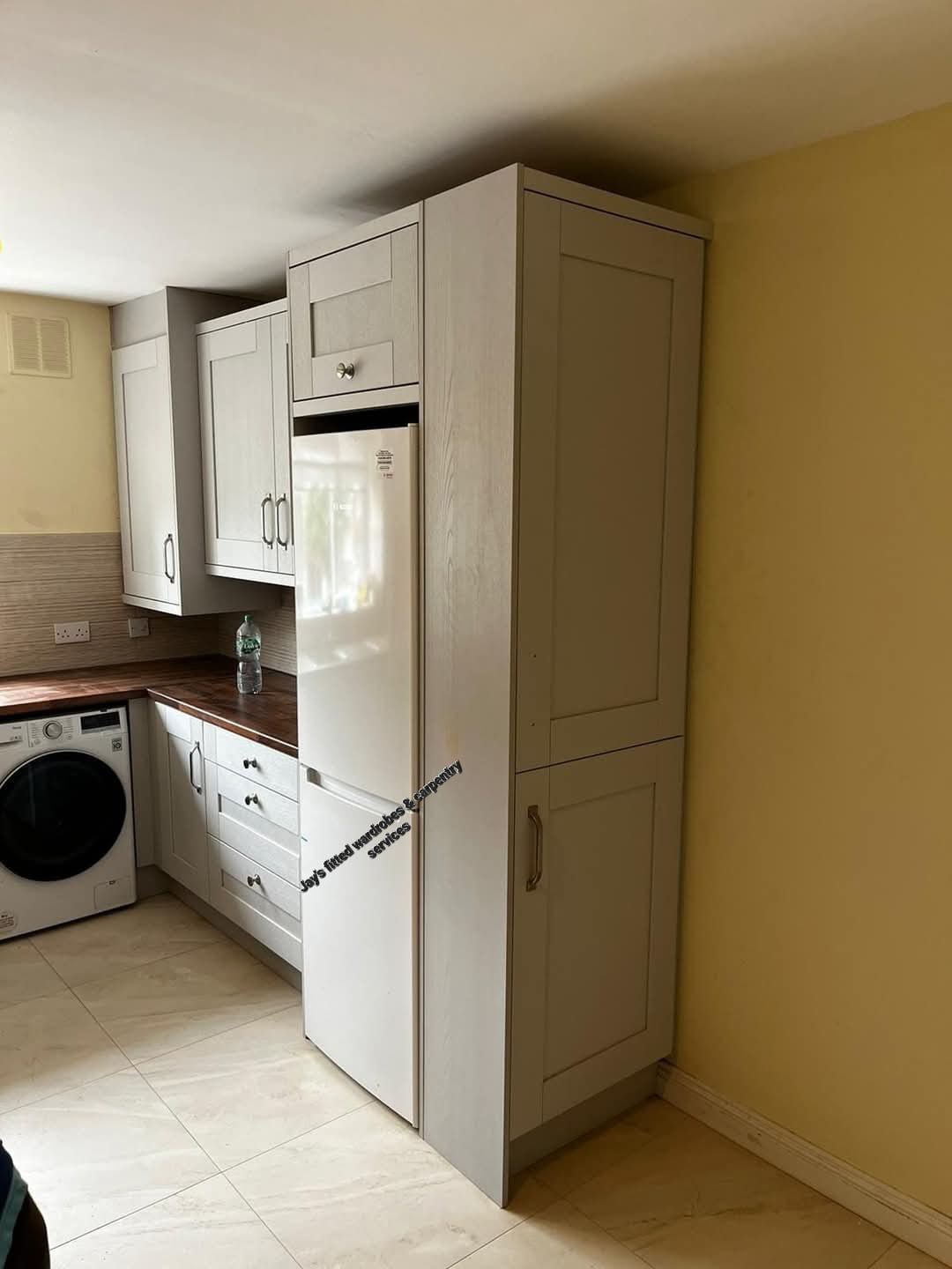 Tall larder unit built in beside the fridge